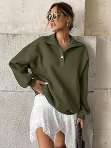 Close-up of oversized army green Henley sweatshirt paired with a white lace skirt