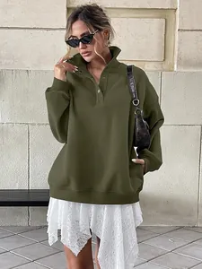 Woman in oversized olive green fleece-lined Henley sweatshirt with button collar