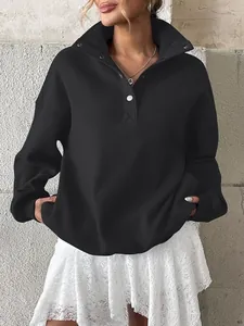 Close-up of black oversized fleece-lined sweatshirt with Henley button lapel collar