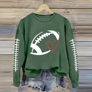 Detailed view of a green sweatshirt with a football and heart print on a wooden hanger