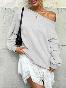 Macro detail view of light gray off-the-shoulder sweatshirt with ribbed slant neckline