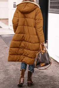 Back view of a long brown hooded puffer coat for women in an outdoor street setting