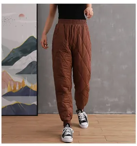 Detailed view of brown quilted down cotton pants with elastic high waist and cuffed hem