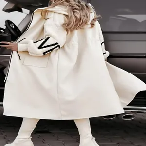 Detail of cream hooded trench coat with black patterned knit sleeves and back view