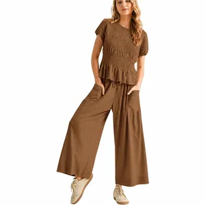 Women's two-piece brown outfit featuring smocked short sleeve top and wide leg pants