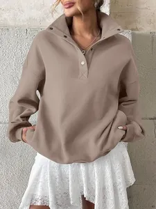 Close-up of women's oversized khaki henley sweatshirt with button collar detail