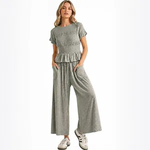 Casual 2-piece grey knit set with smocked short sleeve top and wide leg trousers.