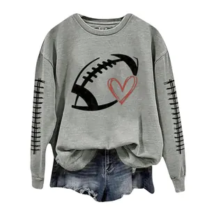 Detail view of a grey women's round neck sweatshirt featuring a football and heart print.