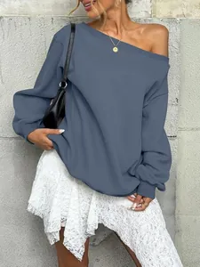 Fashion model wearing a slate blue off-the-shoulder sweatshirt with a white lace skirt