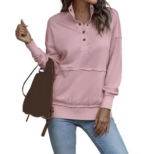 Close-up of pink long-sleeved sweatshirt with button-up collar and front pocket