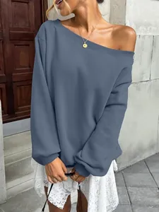 Detail showing a women's off-the-shoulder dusty blue sweatshirt with a relaxed fit.