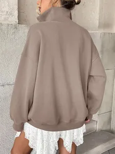 Rear view of oversized taupe fleece sweatshirt featuring a relaxed fit and high collar