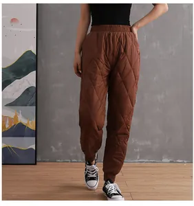 Women's brown quilted padded pants featuring a high waist and ribbed cuffs for winter