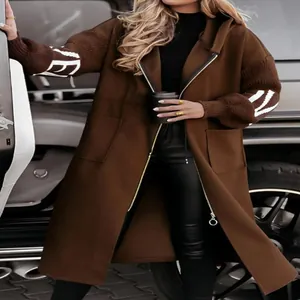 Close-up view of a stylish brown long hooded windbreaker with spliced knit sleeves detail
