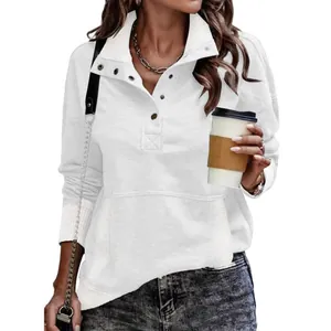 Close-up detail of women's white long sleeve button-down sweatshirt with kangaroo pocket