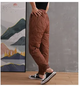 Side view of women's brown quilted padded pants showing warm diamond pattern details