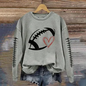 Detailed macro view of a casual grey sweatshirt with football and heart graphic print.
