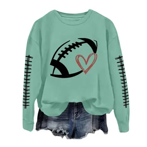 Detailed view of mint green women's sweatshirt with rugby ball and heart graphic design.