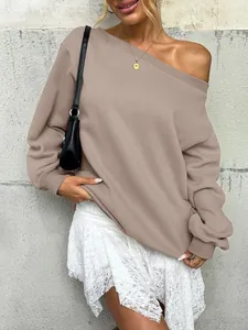 Elegant off-the-shoulder taupe sweatshirt styled with a delicate white lace skirt for autumn.