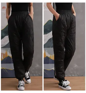 Detailed front and side views of women's black diamond-quilted high-waist padded warm trousers