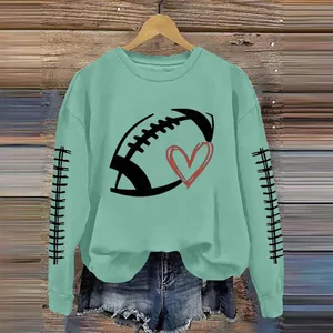 Detailed view of women's mint green sweatshirt with football and heart graphic print