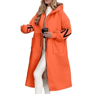 Detail of long orange hooded windbreaker with black lettered knit sweater sleeves