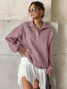 Side view of an oversized mauve Henley sweatshirt with button-down collar detail