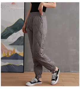 Close-up view of grey quilted down cotton pants with elastic cuffs for winter wear