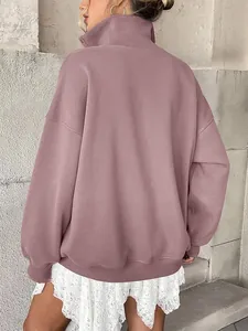 Back view of an oversized mauve fleece-lined sweatshirt with long sleeves and high collar.