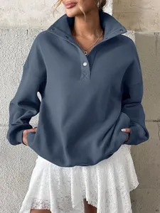 Detailed view of women's oversized blue Henley collar fleece-lined sweatshirt.