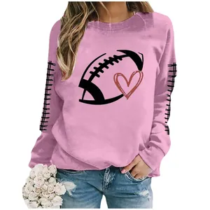 Detail of women's pink long sleeve sweatshirt with football and heart graphic print.