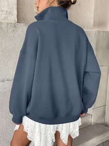 Back view of oversized blue sweatshirt with high collar and cozy fleece lining.