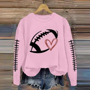 Close-up detail of pink women's sweatshirt featuring a football heart graphic print.