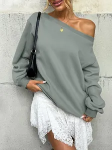 Close-up of a stylish women's off-shoulder solid color sweatshirt in sage green