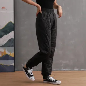 Women's black quilted down cotton pants with high waist and jogger cuffs for winter