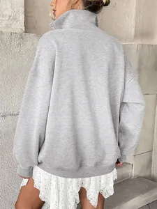 Back view of a grey oversized long sleeve Henley sweatshirt with a stylish lapel design