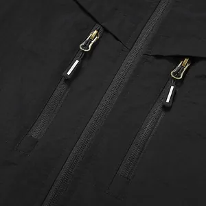 Close-up detail of a men's black casual jacket with functional dual chest zippers