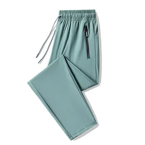 Lightweight ice silk sports joggers for men in mint green with zippered pocket.
