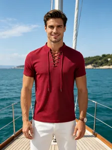 Close-up of a men's burgundy short-sleeved lace-up T-shirt worn on a sailboat deck