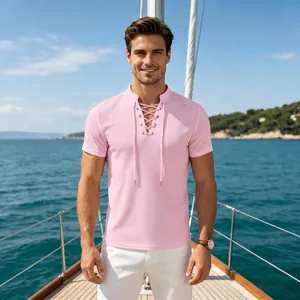 Detail view of pink men's casual T-shirt featuring a lace-up V-neck design on boat