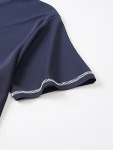 Detailed close-up showing white contrast stitching on a navy blue seersucker short sleeve