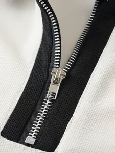 Nahaufnahme des glatten Metallreißverschlusses an einem hochwertigen Herren-Poloshirt.