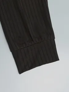 Close-up of ribbed cuffs on a black men's long-sleeved polo shirt showing fabric texture