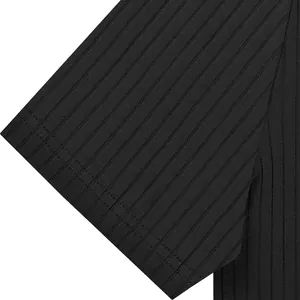 Macro detail of the black ribbed fabric texture on a short-sleeved polo shirt