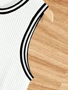 Detail view of white ribbed knit men's tank top featuring black striped trim armhole
