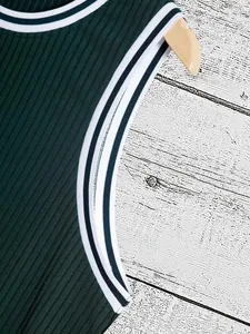 Close-up of dark green ribbed knit tank top with striped neckline and armhole detail
