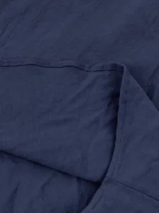 Detailed macro shot of navy blue breathable cotton linen fabric on a men's shirt
