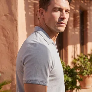 Herren-Poloshirt aus Waffelstrick mit geometrischem Muster an Kragen und Bündchen.