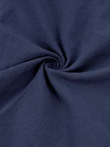 Detailed macro close-up of navy blue cotton-linen fabric texture showing natural weave and drape