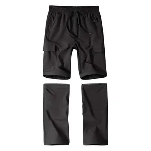 Detail of black convertible cargo pants showing detachable legs and multi-pockets